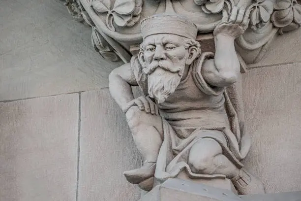 Photo of Sculpture of an old small and bearded funny man, dwarf, as an at