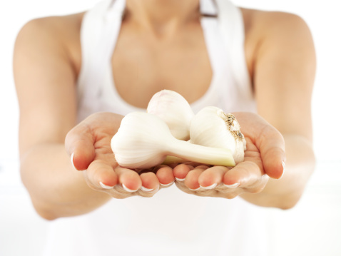 woman holding fresh garlic