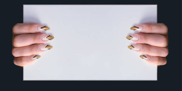 istock Woman with gold pointed stiletto  nails holding a whiteboard with copy space 1181663195