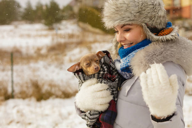 istock Woman hug warming her little dog in winter 1181664005