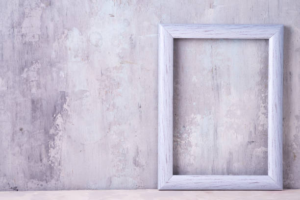 istock gray photo frame on old stone background with copy space. Mock-up frame 1181664019