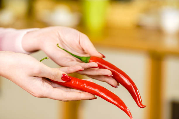 istock Woman holding chilli hot pepper 1181668190