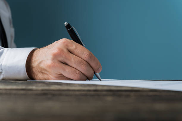 istock Businessman or lawyer signing a document 1181669040