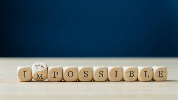 Changing word impossible into its possible Word impossible spelled on wooden dices with the second one turning to spell the Its possible sign. possible stock pictures, royalty-free photos & images