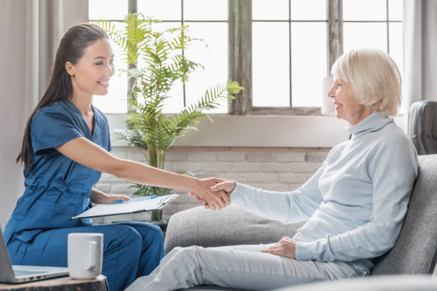 istock Mature woman thanking caregiver for help and support 1181670567