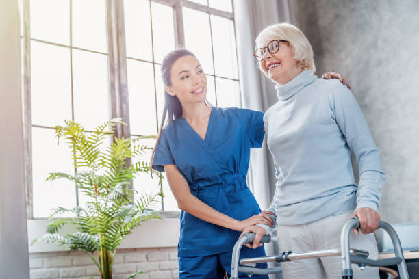 Female asian nurse helping senior woman to walk with walker at home Senior Adult, Nurse, Patient, Care, Assistance orthopedics photos stock pictures, royalty-free photos & images