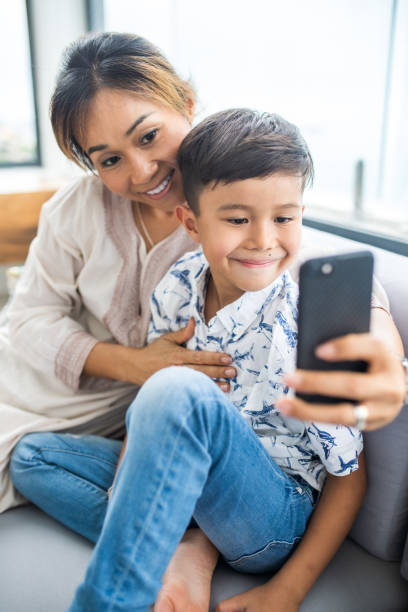 istock Thai family using technology in their everyday live. Taking selfies. 1181671672
