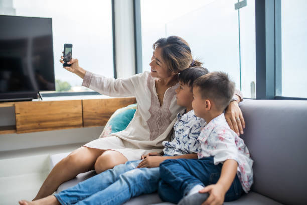 istock Thai family using technology in their everyday live. Taking selfies. 1181671741