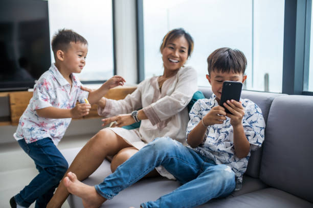 istock Thai family using technology in their everyday live. Taking selfies. 1181671831