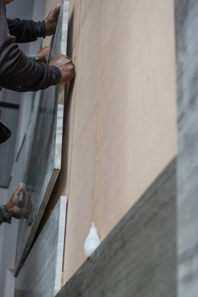 istock laying marble on wall, installing marble  in construction site. 1181671974