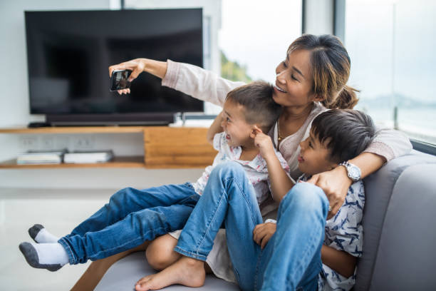 istock Thai family using technology in their everyday live. Taking selfies. 1181672232
