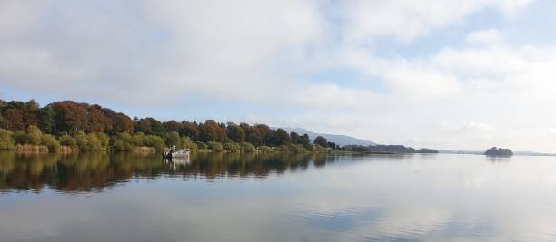 istock Trees reflected in calm waters of Scottish loch 1181673141