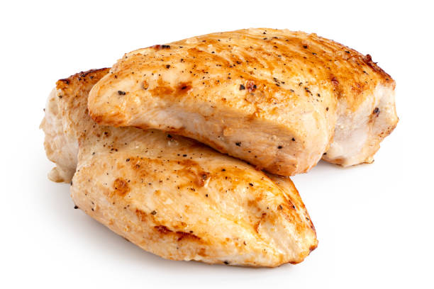 istock Two whole pan roasted chicken breasts isolated on white. 1181673186