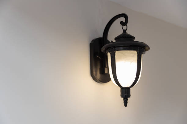 istock close up view of single classic black lamp or lantern on white wall. 1181675835