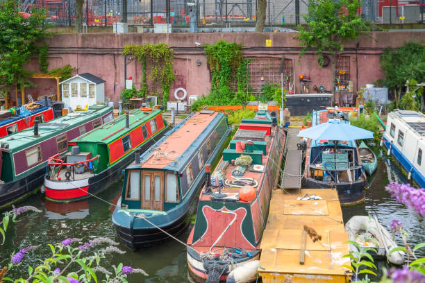 Narrow boats at Lisson Grove mooring site, part of Regent's Canal in London Row of narrow boats at Lisson Grove mooring site, part of Regent's Canal in London little venice london stock pictures, royalty-free photos & images