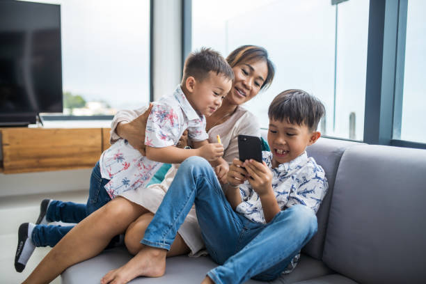 istock Thai family using technology in their everyday live. Taking selfies. 1181676442