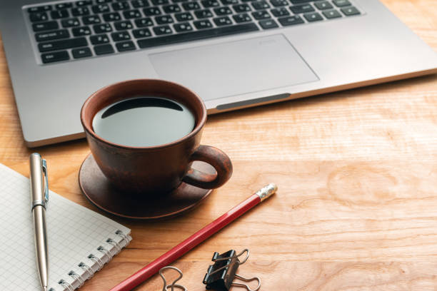 istock Work wooden office table with laptop, coffee cup, notepad and pen 1181677006