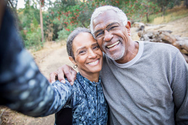 Senior Black Couple Taking Selfie During Exercise A beautiful senior African American Couple takes a selfie during their workout cheek cell stock pictures, royalty-free photos & images