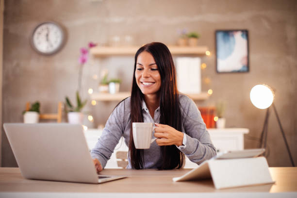 istock Young woman freelancer enjoying work and coffee. 1181688071