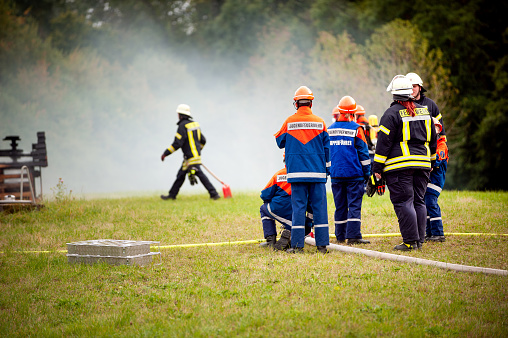 Germany, Niederstetten, Baden Wurttemberg. September 2019 Young firefighters in training after extinguishing the fire.