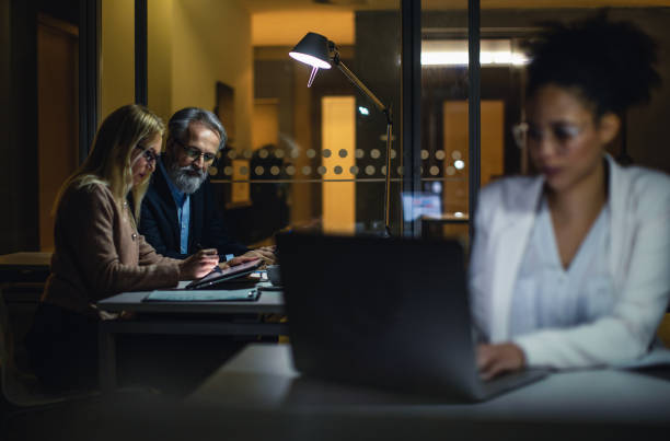 istock Business People Working Late in The Office 1181690958