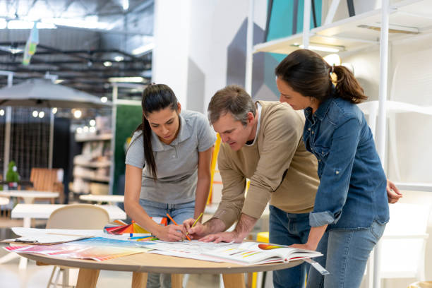 istock Team of creative designers and architects working at a home store on a home renovation using blueprints and color swatches 1181691078