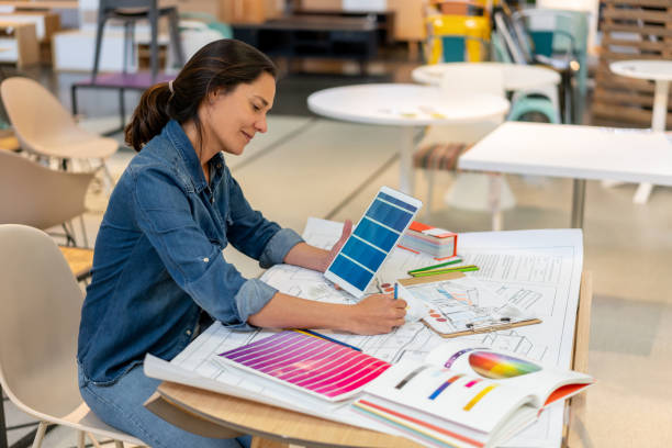 istock Creative designer working on a home renovation sketch using dofferent color swatches and tablet at a furniture store 1181691167