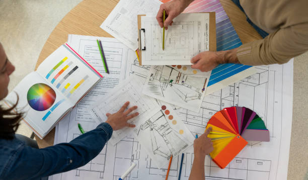 istock Team of unrecognizable creative designers and architects working on a home renovation using blueprints and color swatches 1181691213