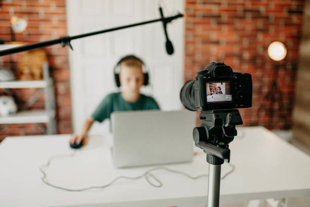 istock Boy in headphones playing video game on laptop 1181692263