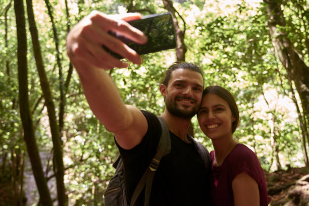 istock Young man taking a selfie in the forest 1181692773