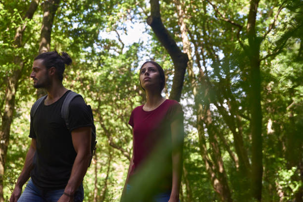 istock Couple strolling among the trees in the forest 1181692893