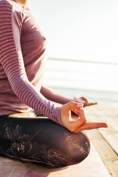 istock Beautiful woman practicing yoga on the seashore at dawn 1181692971