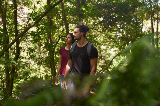 istock Couple walking through a lush forest 1181693865