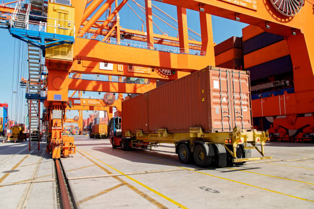 istock Cargo ship being loaded with containers at port. 1181695010