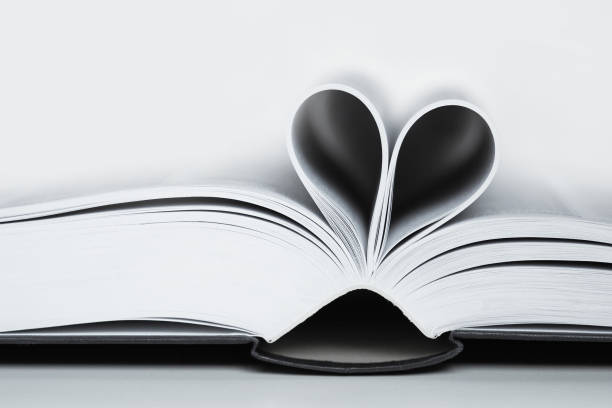 istock Open book, black and white image. Heart shaped book sheets 1181695115