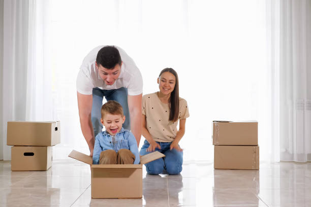 istock father rides happy small son in large empty cardboard box 1181695441