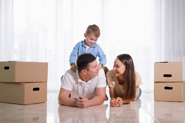 istock child sits on father back lying on light floor in new house 1181695461