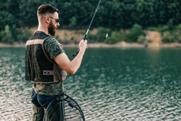 istock Young man fishing 1181695464