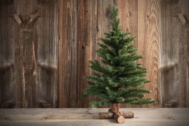istock One Christmas Tree, Brown Rustic Wooden Background Or Texture 1181695681