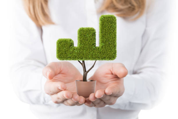 istock Businesswoman holding graph shaped plant 1181696884