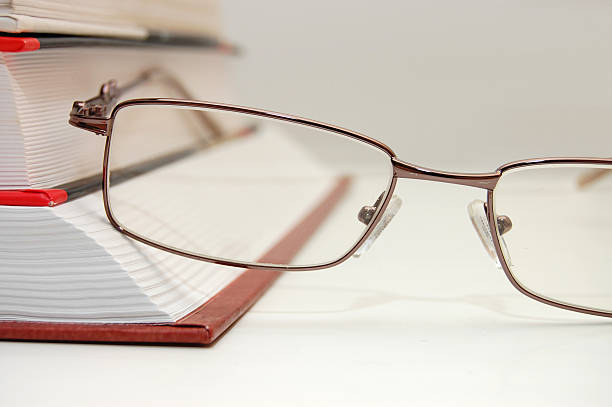istock spectacles laying on the closed book 118170015
