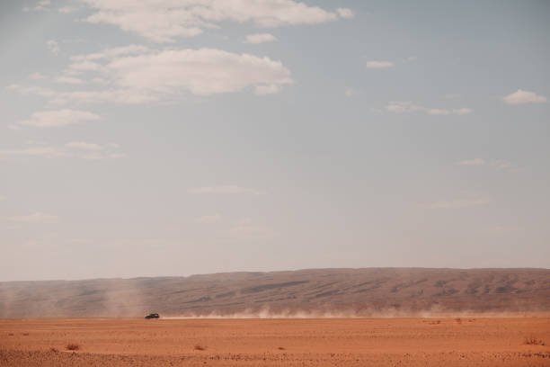 istock Jeep fast rides through the desert with smoke trail 1181701376