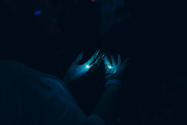 istock Hands and lasers in a night club 1181701431