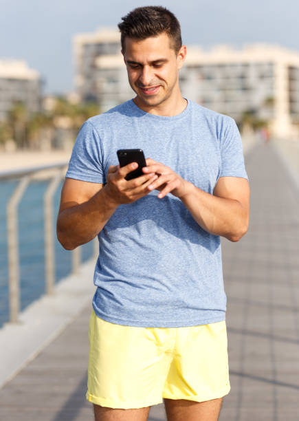 istock Athletic man talking by phone 1181702970