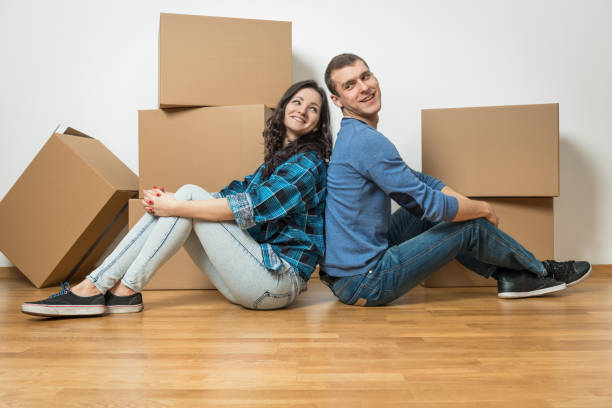 istock Two young couple moving house 1181704360