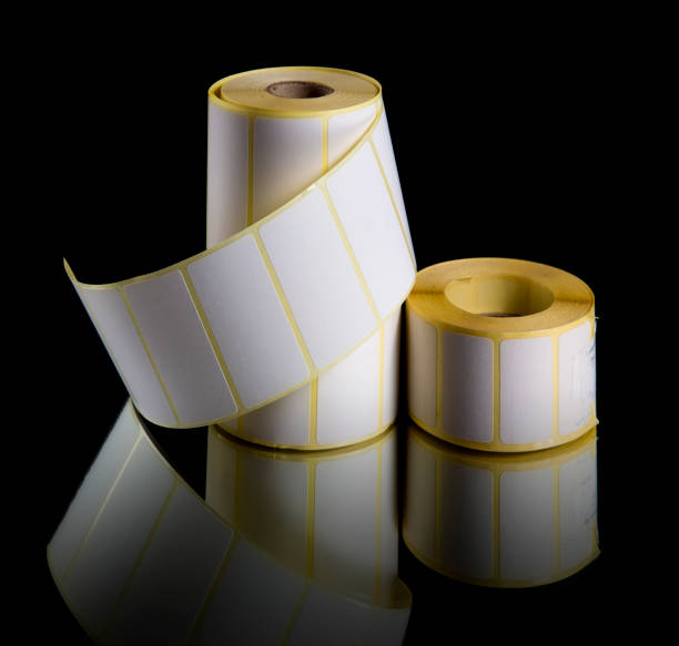 istock Print labels in rolls isolated on black background 1181708952