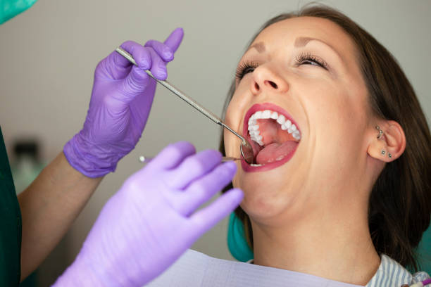 istock Woman teeth and a dentist mirror 1181712135