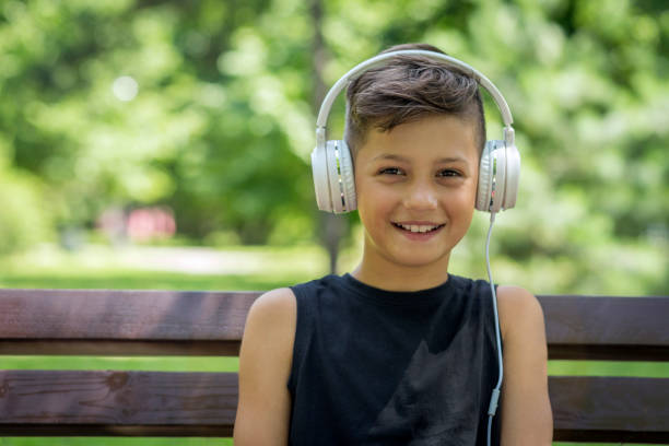 istock Happy boy wearing headphones 1181715189