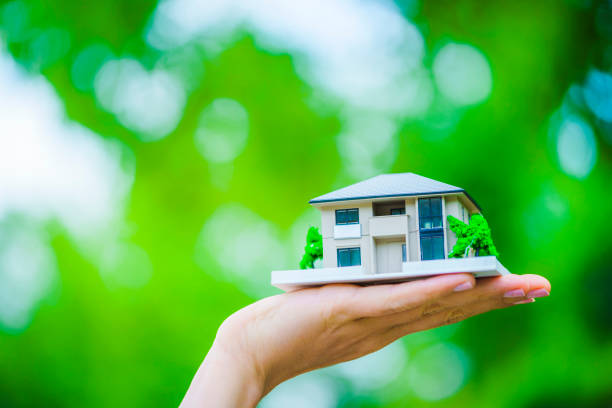 istock Green background with people with house model 1181716425