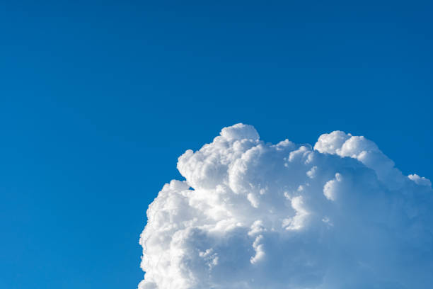 istock Blue sky white cumulus clouds before storm in summer cast shadow 1181716579
